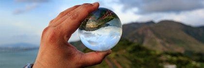 Looking at a mountain through a glass globe.