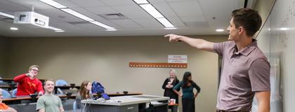 Professor pointing at students in lecture hall