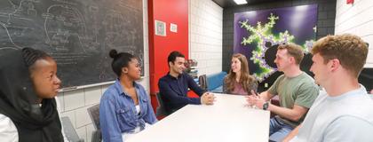 People sitting around table in discussion