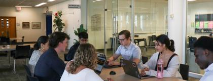 7 students studying around a table in the Math & Stats Learning Centre.