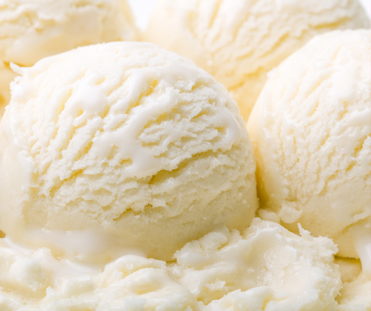 Close up of white scoops of ice cream.