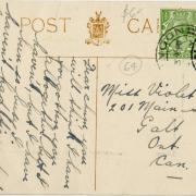Back of a postcard addressed to Violet with a green stamp and handwriting.