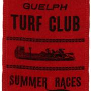 Red Guelph Turf Club Summer Races ribbon with a picture of racing horses in black.