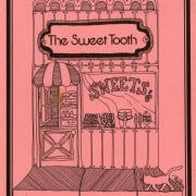 The Sweet Tooth cookbook with pink cover and hand-drawn sweet shop.