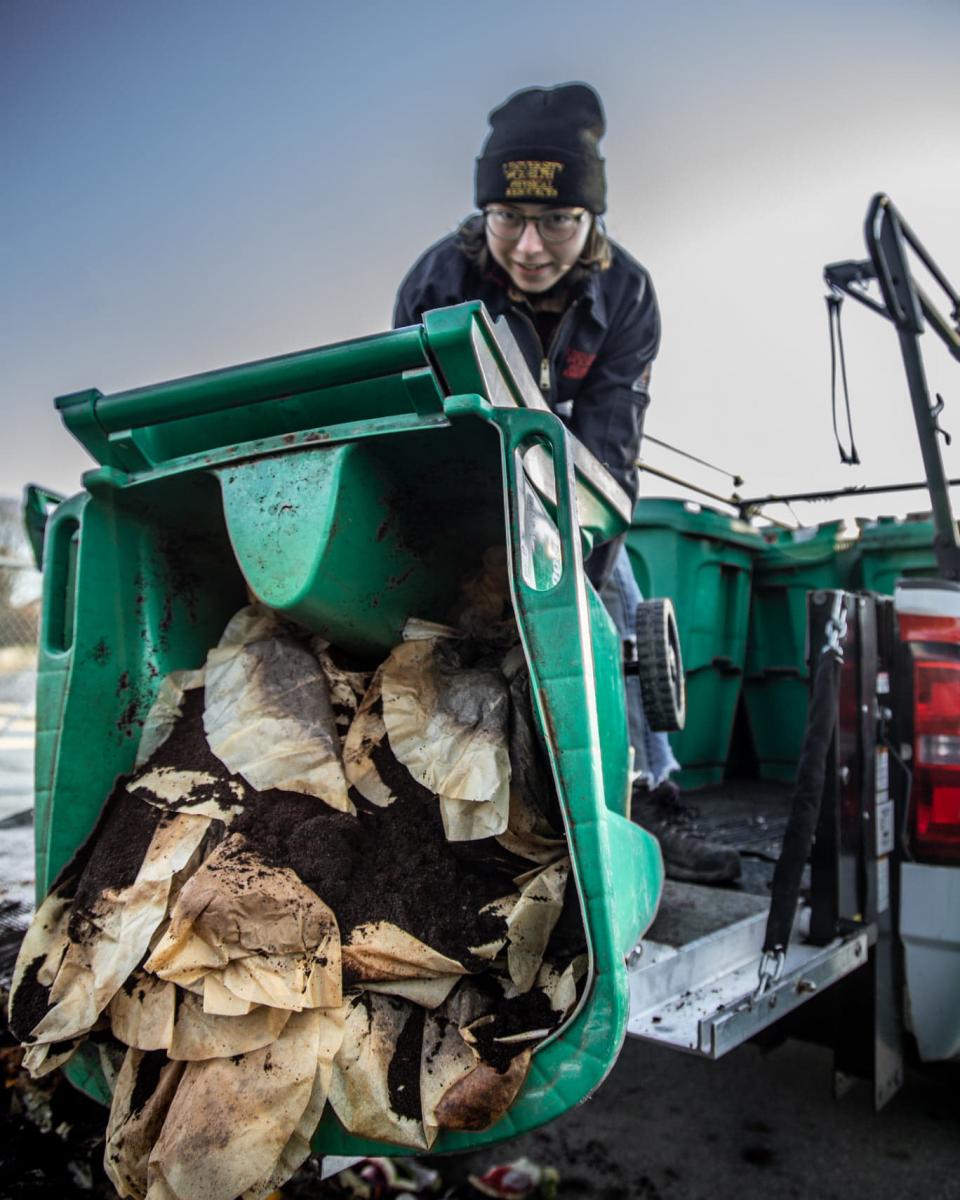 two UofG staff pose with office compost bins