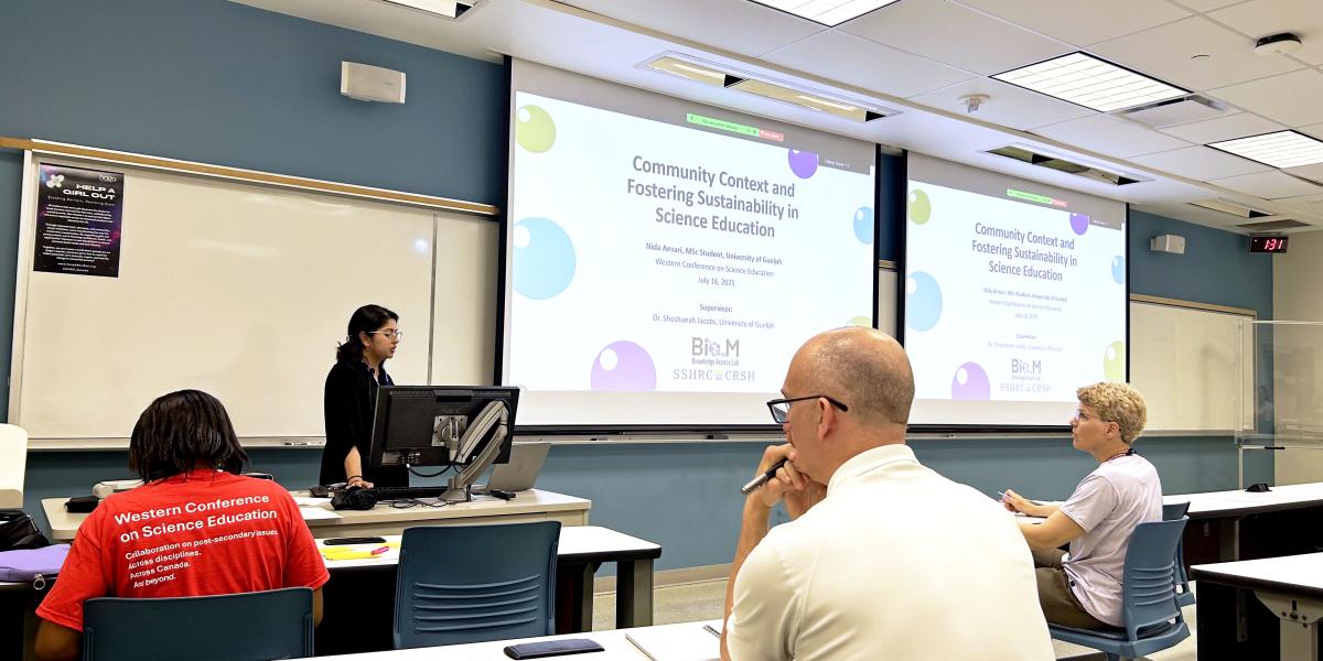Nida Ansari presents in front of a classroom