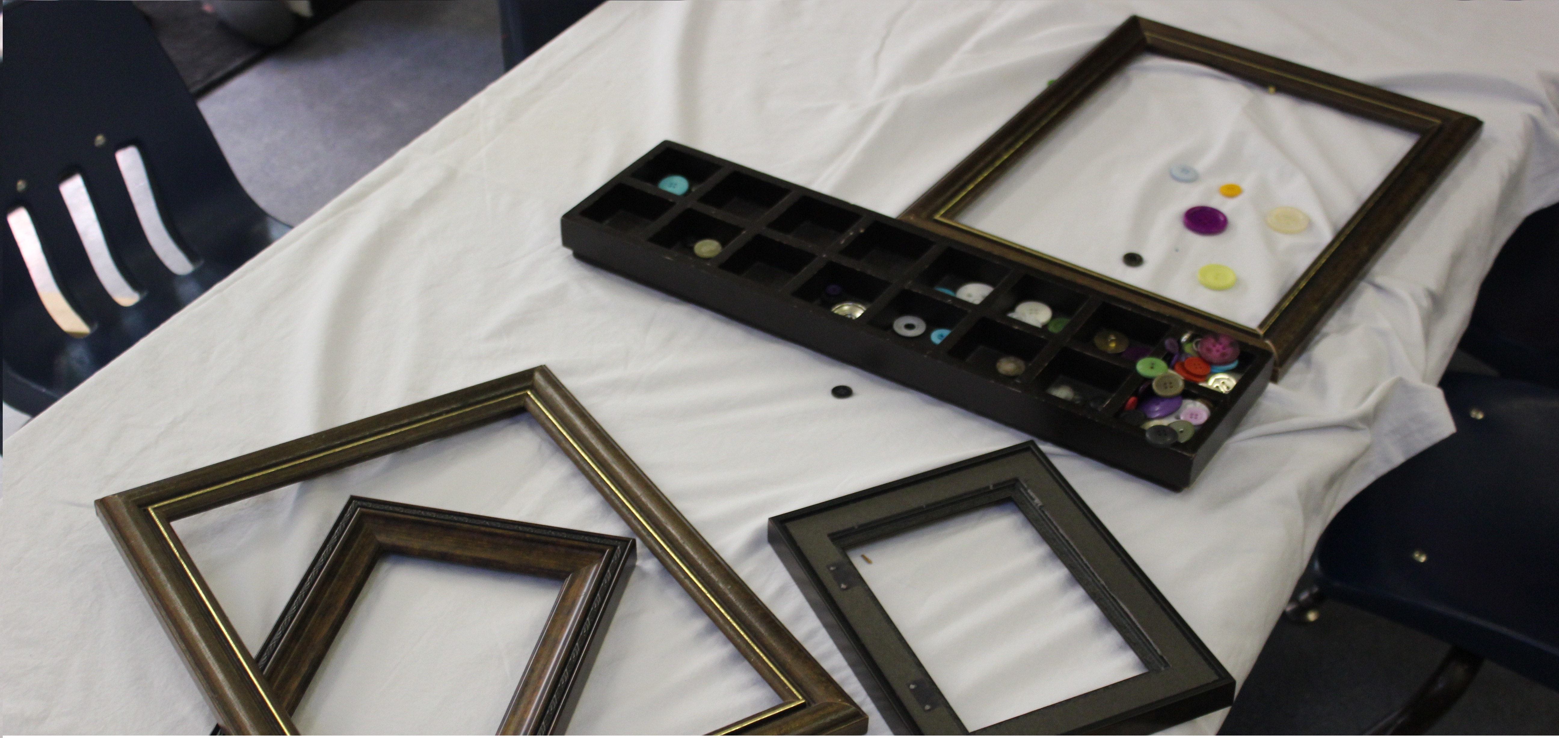 Picture frames and buttons on a table.