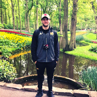 Student stands in front of the worlds largest garden, in The Netherlands