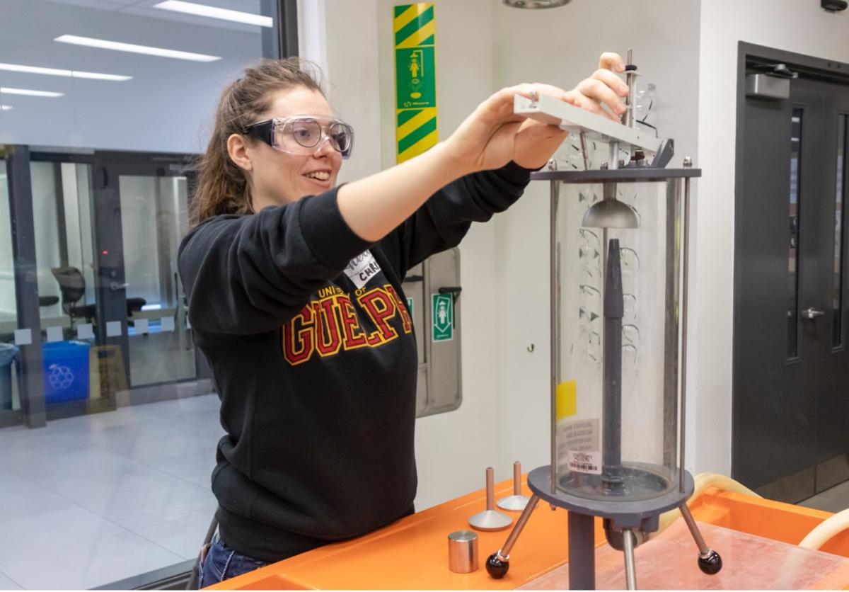 Female student performing an experiment in the fluid mechanics lab.