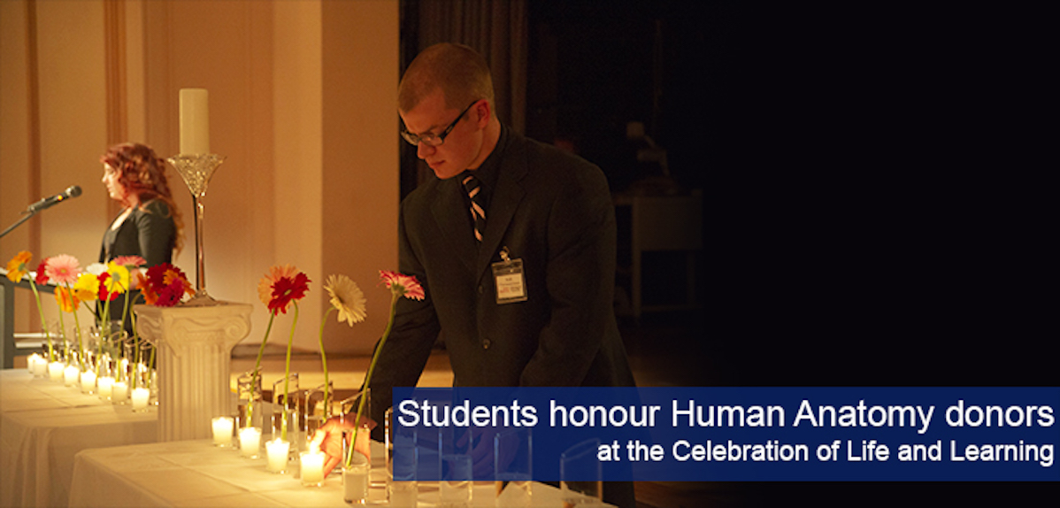 A photograph of undergraduate students lighting candles at the Celebration of Life ceremony.