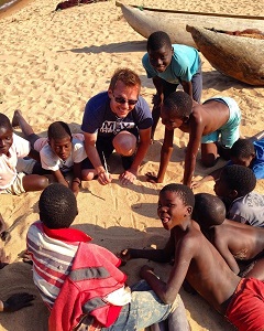 This is a picture of Daniel Gillis, U of G Assistant Professor and Statistician in the School of Computer Science on Leave for Change in 2017 as Database Management Advisor with the Agricultural Research and Extension Trust (ARET) in Malawi. He is pictured here teaching math to children on a beach.