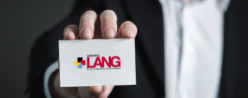 hand holding a lang school business card