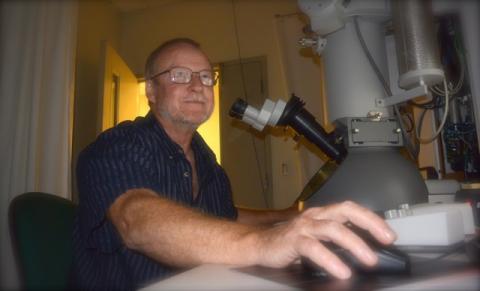 Robert Harris works on a microscope