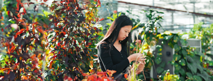 student in a green house