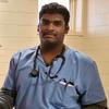 Keerth in blue scrubs wearing a stethoscope