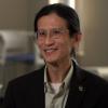 Loong-Tak Lim in fine rimmed glasses and brown suit jacket.