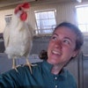 Claire takes a selfie photo with white chicken on her shoulder.