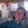 Claire takes a selfie photo with white chicken on her shoulder.