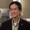 Loong-Tak in metal frame glasses, suit jacket and pale green dress shirt
