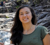 vanessa sitting on a rock next to a river