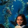 Keya Sarkar, MFB student, standing in front of an aquarium