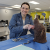 vet students with canine dental model