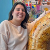 Jessica Seifried poses with a giant cardboard bagel