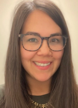 Women smiling at camera with big glasses on.