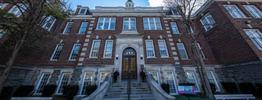 The front steps and entrance of a large red brick building