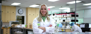gillian in a food lab with hands crossed wearing a lab coat