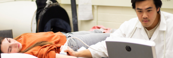 Student uses ultrasound machine to examine arm
