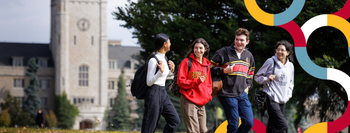 Four students on Johnston Green with colourful design