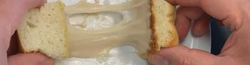 Cheese stretching between two pieces of bread