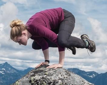 Mia Kilborn balancing on top of a mountain.