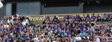 Large group of high school students in purple shirts sitting on bleachers at the University of Guelph for a Battle STEM event.