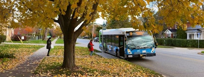 Student getting on Guelph Transit bus in Fall.