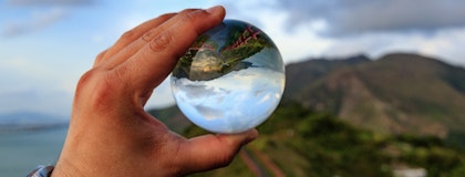 Looking at a mountain through a glass globe.