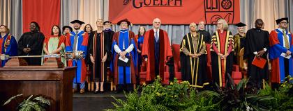 university executives standing on stage at convocation