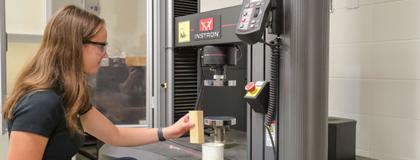 Student in the Engineering Lab using a testing system.