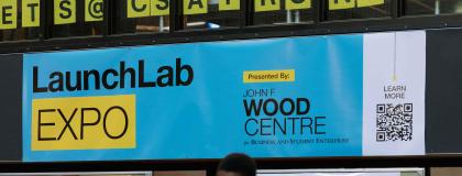 Blue background with a black and yellow logo with text that reads' LaunchLab Expo'