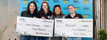 3 individuals holding cheque