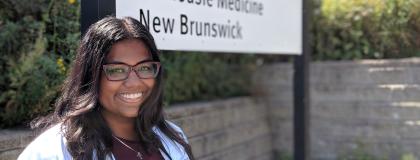 Dr. Naythrah Thevathasan standing in front Dalhousie Medical school.