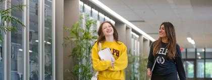 2 students walking down the hall