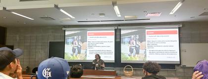 A group of students sits in a lecture/discussion about learning to be camp instructors