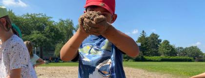 Creative Encounters camper playing with sand