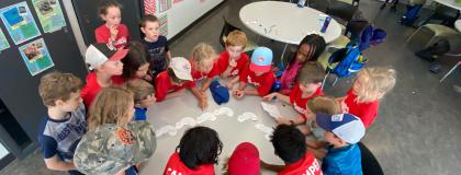 Creative Encounters campers gathered around a table