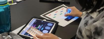 Creative Encounters camper using an Ipad to learn about ai and programming