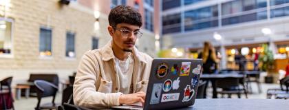 U of G student works at his laptop.