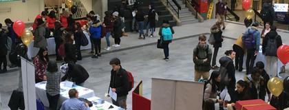 Students speaking with exhibitors at the Financial Literacy Fair in the University Centre Courtyard.