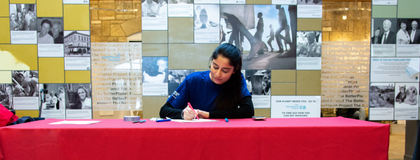 A student sitting at an event booth